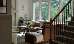 Sunlit living room beside the staircase.