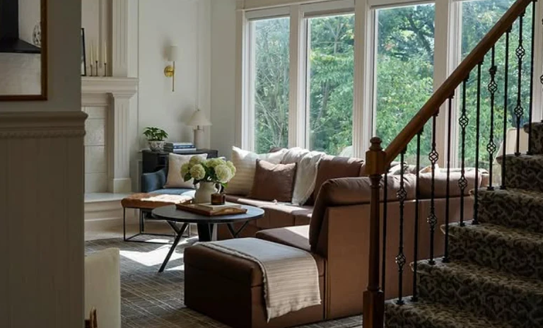 Sunlit living room beside the staircase.